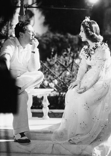 7th April 1936: Director George Cukor chatting to Norma Shearer on the set of the lavish MGM production of Shakespeare&apos;s &apos;Romeo and Juliet&apos;. Norma Shearer earned an Academy Award for her performance as Juliet. (Photo by William Grimes/John Kobal Foundat